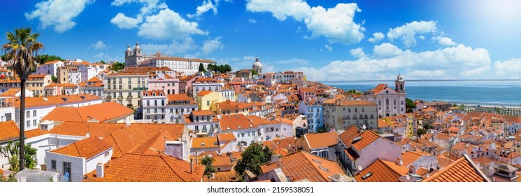 Panoramic view of the beautiful skyline of Lisbon, Portugal, with red roofed, colorful houses in the Alfama district during a sunny day - Shutterstock ID 2159538051