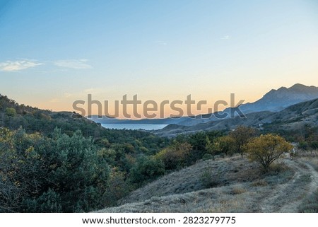 Panoramic view of a beautiful sunset over Kara Dag and the Black Sea in Crimea.
