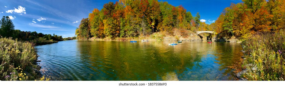 Panoramic view of Beebe Lake, with Sackett's Bridge. Beebe Lake is a sanctuary of water, woods, and wetlands in the heart of the Cornell Campus, Ithaca, NY. Students enjoying boating in the lake.
