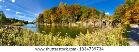 Panoramic view of Beebe Lake, with the trail and Sackett's Bridge, in Ithaca, New York. Beebe Lake is a sanctuary of water, woods, and wetlands in the heart of the Cornell Campus. Picturesque scenery 