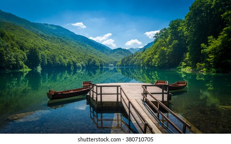 Panoramic view of Biogradsko lake. Virgin forests and beautiful mountains, wooden pier and boats. National park Biogradska gora is very popular touristic destination in Montenegro.