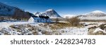 Panoramic view of black rock cottage with buachaille etive mor in distance on snow covered rannoch moor, near fort william, highland, scotland, united kingdom, europe