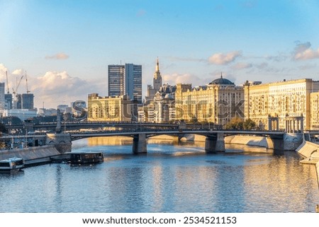 Panoramic view Borodinsky bridge, river Moscow, old buildings and high towers. View of the Borodinsky Bridge and the embankment in Moscow. Urban perspective of Russia capital downtown