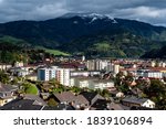 panoramic view of Bruck an der Mur city and the Rennfeld mountain in Styria, Austria on a sunny-cloudy autumn day