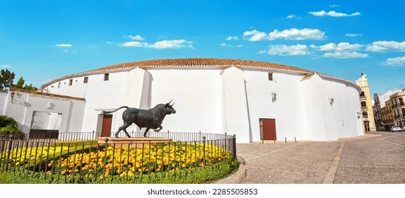  Panoramic view to bullfight arena on Plaza de Toros square with bronze sculpture in Ronda. Malaga province, Andalusia, Spain   