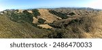 Panoramic view of California Central Coast hillsides. Large areas of green remain, the gift of heavy winterspring rainfall