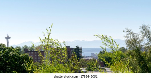 Panoramic view from Capitol Hill in Seattle of the Olympic Mountains in West Washington, Puget Sound, and buildings on Queen Anne Hill in Seattle on a summer day in July.
