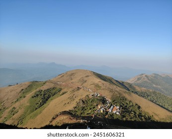 Panoramic view capturing mountainous terrain from a lofty, elevated perspective.