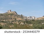 Panoramic view of the castle of Alburquerque or Luna castle on top of a hill and to the right the city of Alburquerque on a summer day with blue sky. 