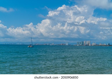 Panoramic View Of A Catamaran Sailboat In Puerto Vallarta, Mexico With The Hotel Zone In The Background