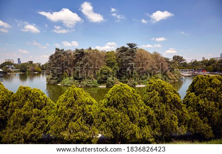 Panoramic view of Chapultepec public park or forest, 2nd section, and one of its minor lakes, Mexico City skyline.