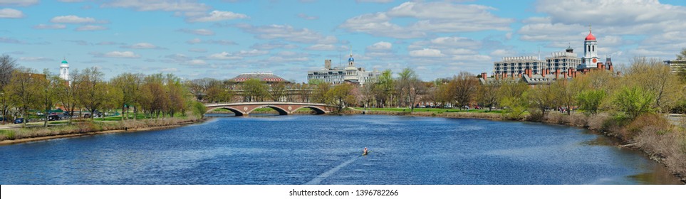 Panoramic view of Charles River and Harvard University campus in early spring. Cambridge, Massachusetts, USA. Weeks Bridge, colorful domes of student residences, people rowing in the Charles.