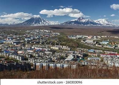 Panoramic view of city Petropavlovsk-Kamchatsky and volcanoes: Koryaksky Volcano, Avacha Volcano, Kozelsky Volcano. Russian Far East, Kamchatka Peninsula.