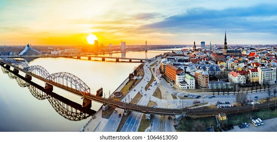 Panoramic view of city Riga,Latvia during late evening sunset. Old railway bridge in foreground. 