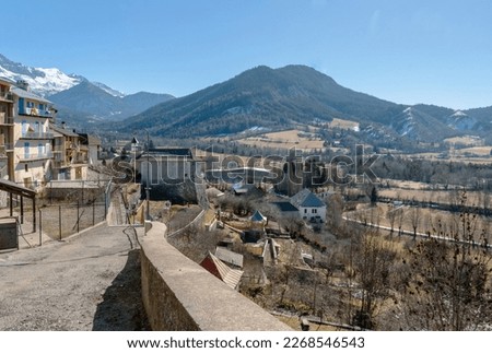 Panoramic view of the city of Seyne (also called Seyne-les Alpes), with the Alps mountains covered with snow in the background.
