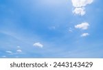 Panoramic view of clear blue sky and clouds, Blue sky background with tiny clouds. White fluffy clouds in the blue sky. Captivating stock photo featuring the mesmerizing beauty of the sky and clouds.