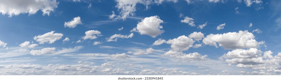 Panoramic view of cloudy sky with ruffled fair weather and cluster clouds against blue sky in sunny weather
