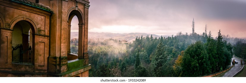 panoramic view of the Colli Bolognesi hills at sunset from the arcades on the hill of San Luca near the homonymous basilica, horizontal background of Bologna in Italy
