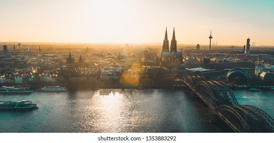 Panoramic view of Cologne, Germany, with Cologne Cathedral, Hohenzollern Bridge and old town at sunset