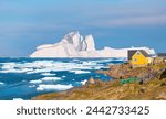 Panoramic view of colorful Kulusuk village in East Greenland - Kulusuk, Greenland - Melting of a iceberg and pouring water into the sea