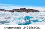 Panoramic view of colorful Kulusuk village in East Greenland - Kulusuk, Greenland - Melting of a iceberg and pouring water into the sea