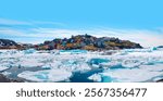 Panoramic view of colorful Kulusuk village in East Greenland - Kulusuk, Greenland - Melting of a iceberg and pouring water into the sea