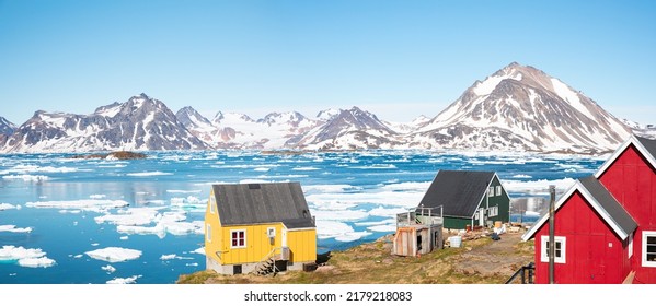 Panoramic view of colorful Kulusuk village in East Greenland - Kulusuk, Greenland - Melting of a iceberg and pouring water into the sea