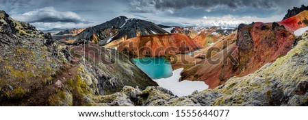Panoramic view of colorful rhyolite volcanic mountains Landmannalaugar as pure wilderness in Iceland and a hidden highland lake, Iceland, summer time