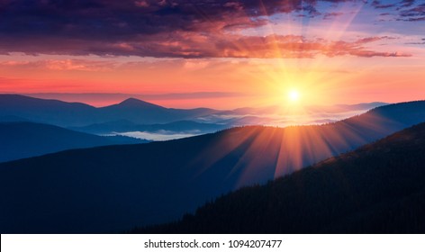 Panoramic view of colorful sunrise in mountains. Concept of the awakening wildlife, romance,emotional experience  in your soul, joy in mundane life. 