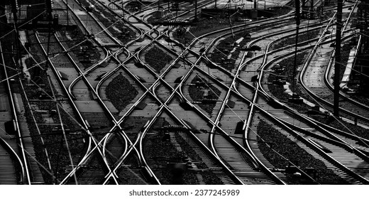 Panoramic view of a complicated system of railway tracks and switches at a big station forming geometrical structures and lines. Main station in Hagen Westphalia Germany, black and white greyscale. - Powered by Shutterstock