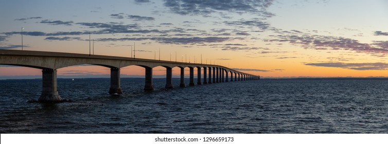 Panoramic View Of Confederation Bridge To Prince Edward Island During A Vibrant Sunny Sunrise. Taken In Cape Jourimain National Wildlife Area, New Brunswick, Canada.