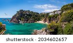 Panoramic view of the Costa Brava seaside of Catalonia, Spain. Coastline of Blanes near Marimurtra garden with small beach and cliffs. Summer holidays and leisure on the Mediterranean resorts.