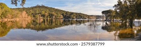 Panoramic view of a dam with crystal clear waters at sunset. Beautiful place for sailing and camping. Darnius dam in Catalonia