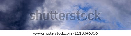 Panoramic view of dark rain clouds beginning to form in the sky
