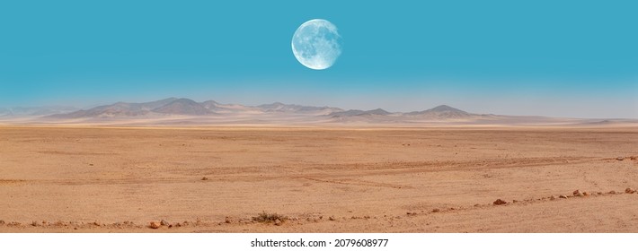 Panoramic view of desert plains in Namibia Africa with hills and mountains in the background - Full moon on the mountains"Elements of this image furnished by NASA " - Powered by Shutterstock