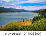 Panoramic view of Dexter Reservoir near Eugene, Oregon, with mountain backdrop. Dexter Reservoir, also known as Dexter Lake, is a reservoir in Lane County formed on the Middle Fork Willamette River.