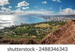 Panoramic View from the Diamond head crater across the Honolulu downtown city shape and the turquoise Pacific Ocean at the background