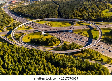 a panoramic view of a difficult road junction with fast moving cars filmed from a drone