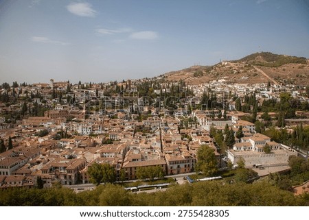Panoramic View of the Albaicín District in Granada, Spain ,Historic Moorish Quarter with Red Tiled Roofs and White Houses ,Aerial View of Ancient Andalusian Hillside Town under Blue Sky
