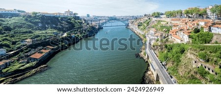 Panoramic view of the Douro river, the Luis I bridge and the city of Porto from Infante bridge, Portugal.