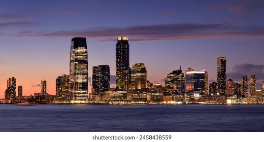 Panoramic view of Downtown Jersey City at twilight. Waterfront view of the Hudon River and Exchange Place skyscrapers, New Jersey - Powered by Shutterstock