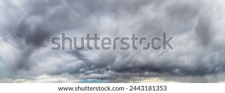Panoramic view of dramatic storm clouds before a thunderstorm.  The view includes only clouds and starts just above the horizon.
