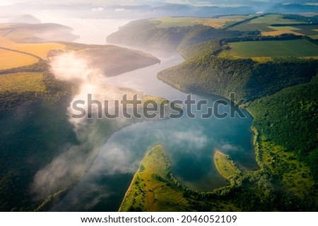 Panoramic view from a drone flying over the meander of the Dniester river. Location place Dnister canyon of Ukraine, Europe. World landmarks. Picturesque photo wallpaper. Discover the beauty of earth.