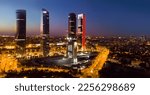 Panoramic view from drone of illuminated Cuatro Torres Business Area at night, Madrid, Spain