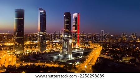 Panoramic view from drone of illuminated Cuatro Torres Business Area at night, Madrid, Spain