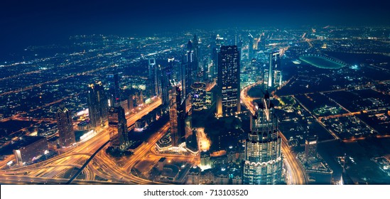 Panoramic view of Dubai city, beautiful modern new town at night with many bright glowing lights from the towers, magical place for traveling - Powered by Shutterstock