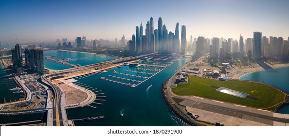 Panoramic view of Dubai Marina skyscrapers and JBR beacg with luxury buildings and resorts in one of the United Arab Emirates travel spots and resorts in Dubai aerial view - Shutterstock ID 1870291900