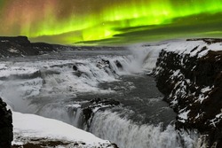 Panoramic View During Aurora Borealis Or Northern Lights Over The Gullfoss Waterfall In The Hvita River Flowing From Hvitarvatn Lake And The Langjokull Glacier In Iceland