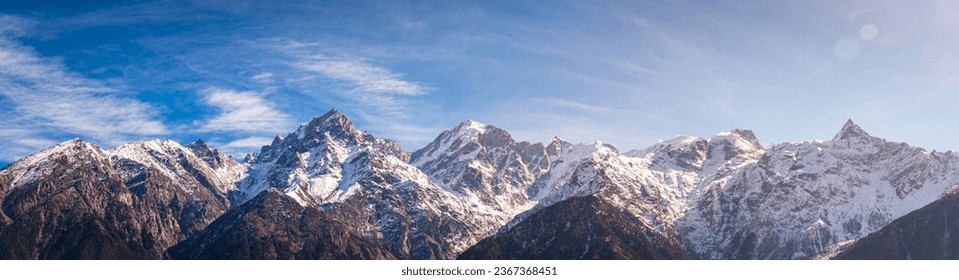 Panoramic view during sunset over snow cladded Kinner kailash mountain peaks falls in Greater Himalayas mountain range from Kalpa village, Kinnaur, Himachal Pradesh, India.