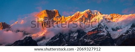 Panoramic view during sunset over snow cladded Kedarnath mountain peaks falls in Gangotri Himalayan mountain range from Kedarnath temple, Rudraprayag, Uttarakhand, India.